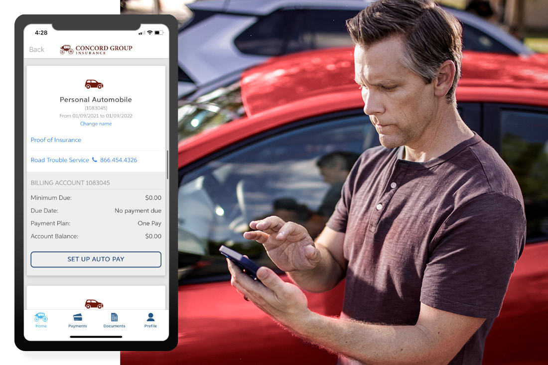 Man on his phone standing in front of his car