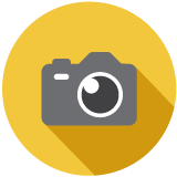 Gray camera on a yellow background