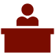 Red person sitting at a desk